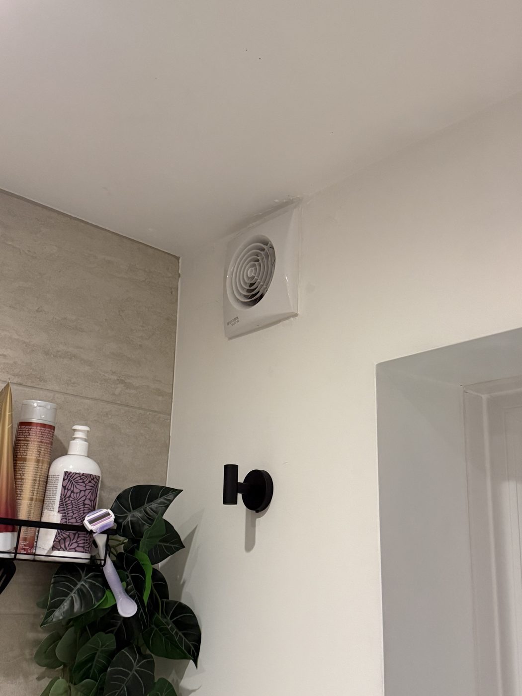 A bathroom extractor fan and light fitted