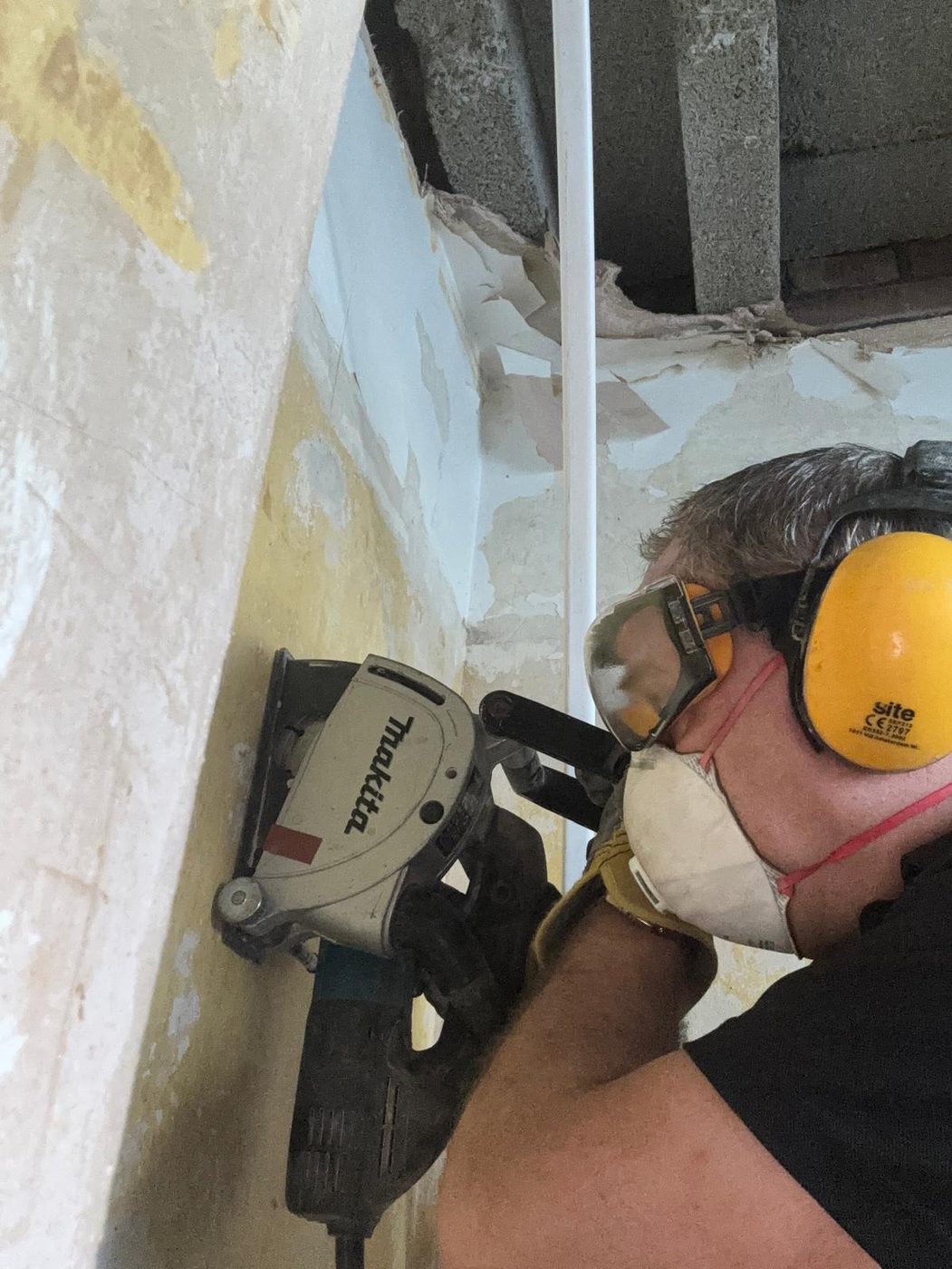 Tony on the tools — chasing in a new circuit on a renovation job